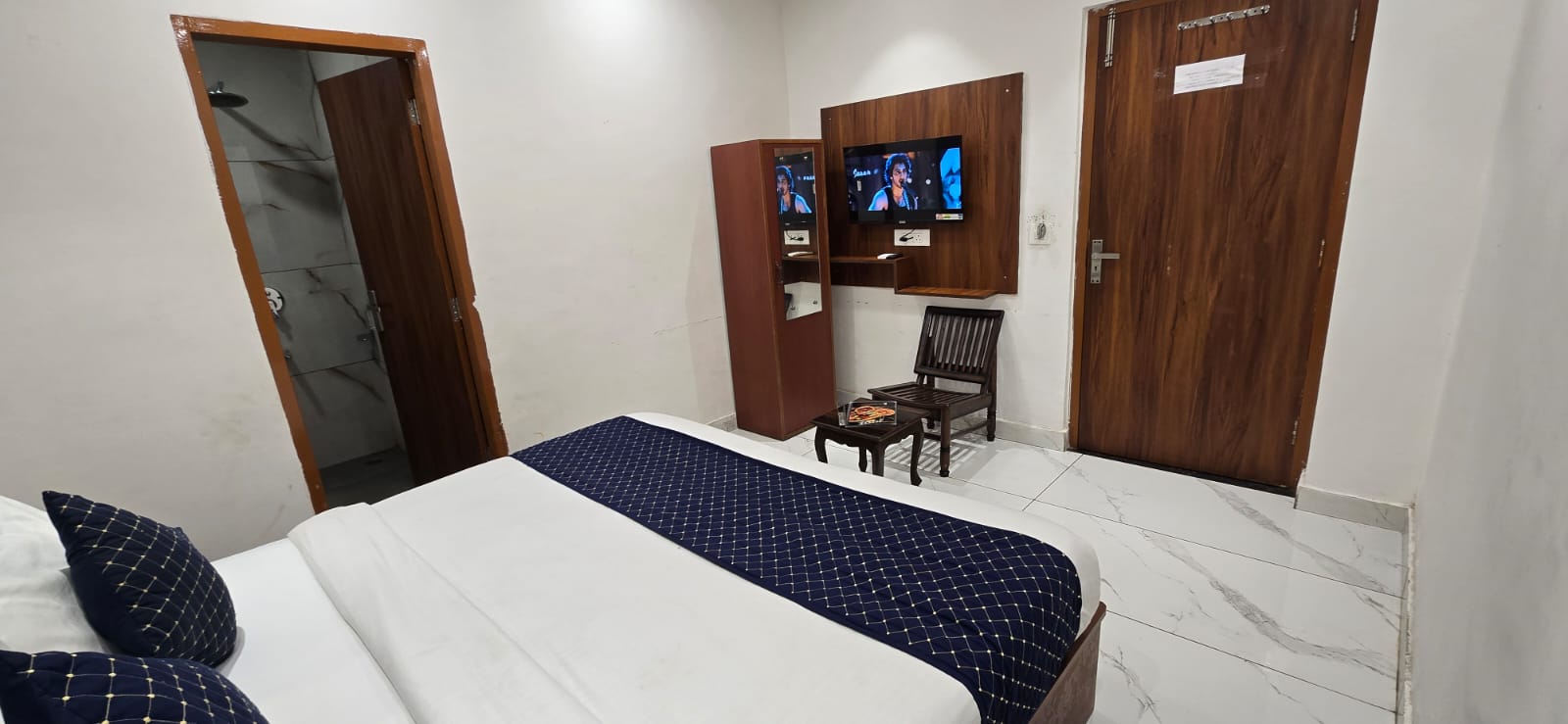 Neat room interior with TV panel and attached washroom